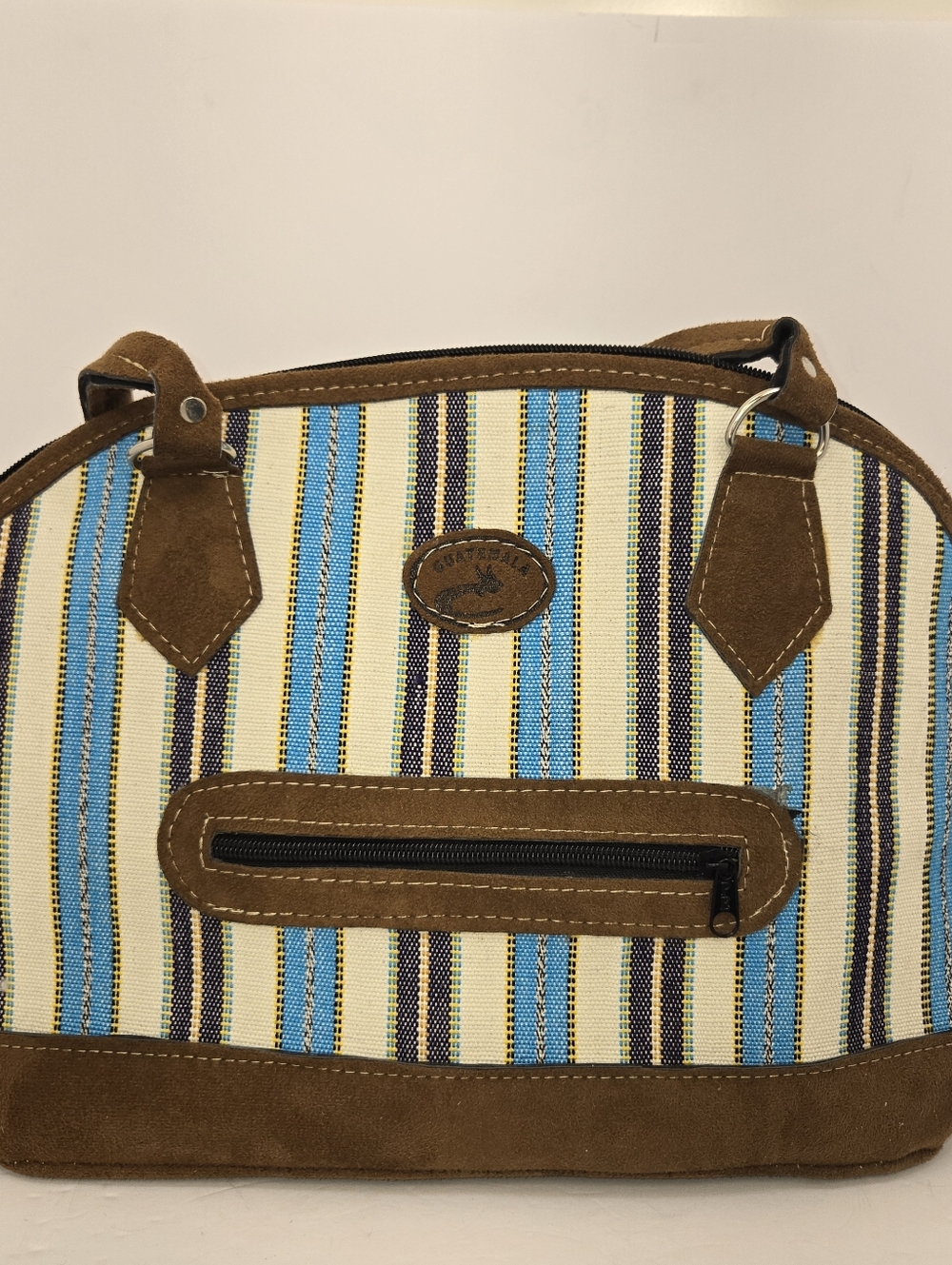 Handcrafted handbag from Guatemala, known for its vibrant striped canvas design